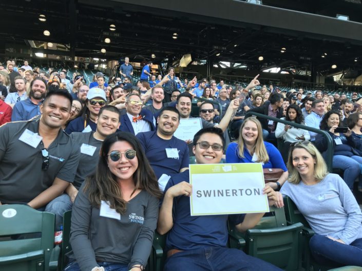 Seattle-Best-Workplaces-2019 Seattle team holding Swinerton sign at baseball stadium