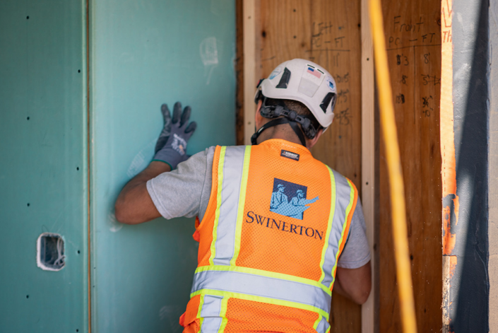 Swinerton Craft Employee-Installing Drywall